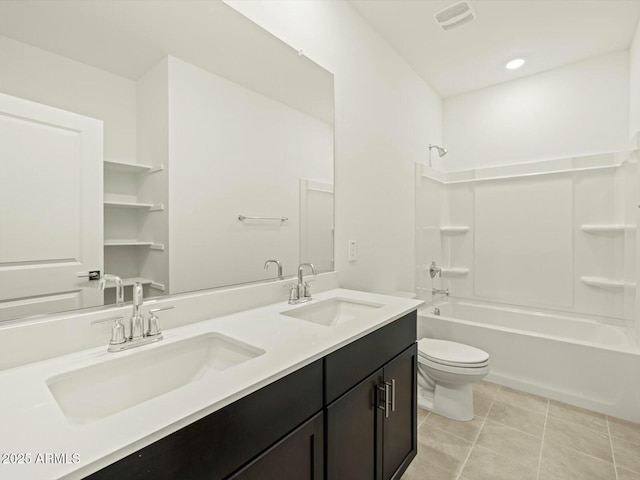 bathroom featuring tile patterned flooring, shower / bath combination, toilet, and a sink