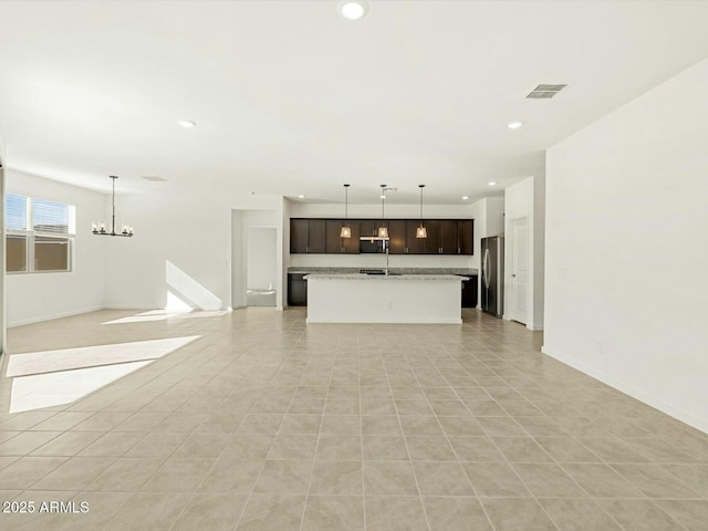 unfurnished living room featuring light tile patterned floors, visible vents, baseboards, recessed lighting, and a chandelier