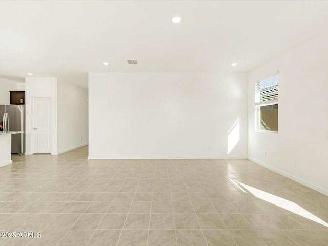 spare room featuring light tile patterned flooring, recessed lighting, visible vents, and baseboards