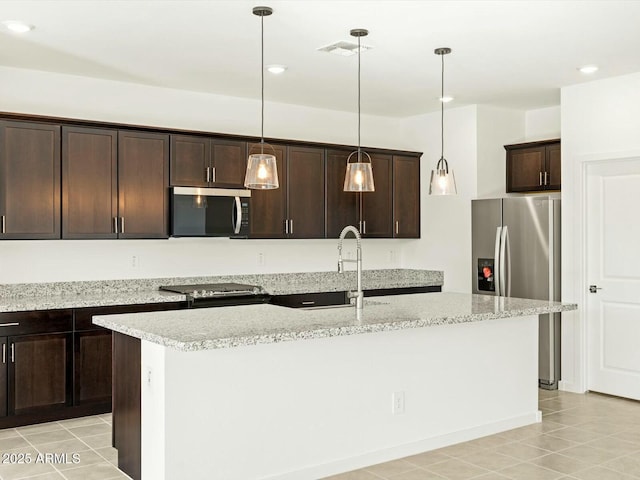 kitchen with visible vents, dark brown cabinetry, a center island with sink, appliances with stainless steel finishes, and hanging light fixtures