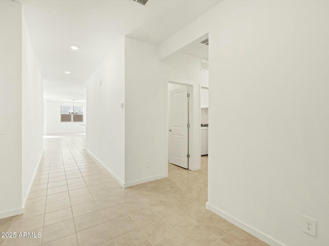 hallway with light tile patterned floors, recessed lighting, and baseboards