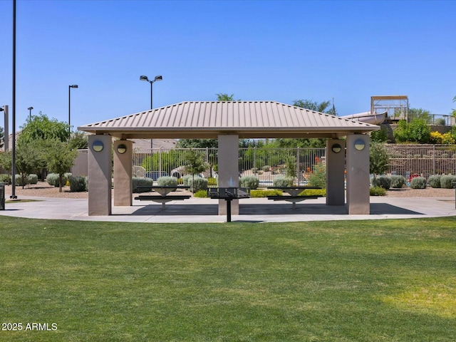 view of home's community with a gazebo, a yard, and fence