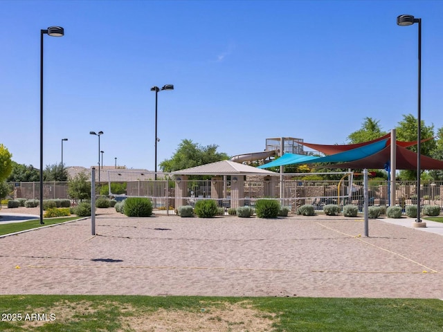 view of community featuring fence and volleyball court