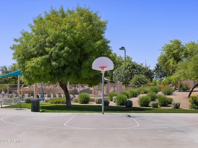 view of basketball court featuring community basketball court, a yard, and fence