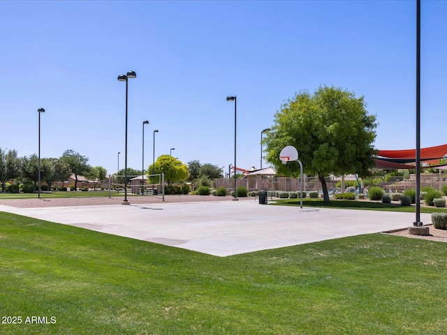 view of sport court featuring volleyball court, community basketball court, a yard, and fence