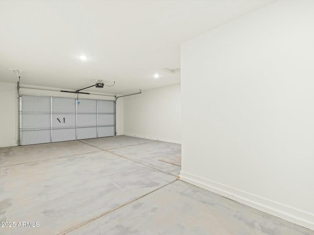 garage featuring a garage door opener and baseboards