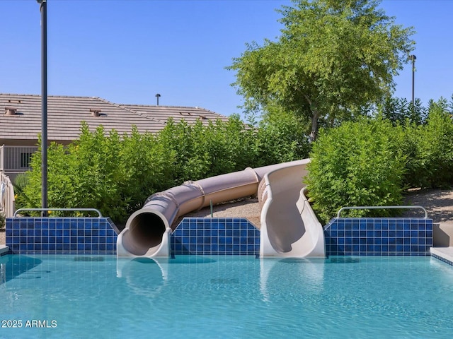 outdoor pool featuring a water slide