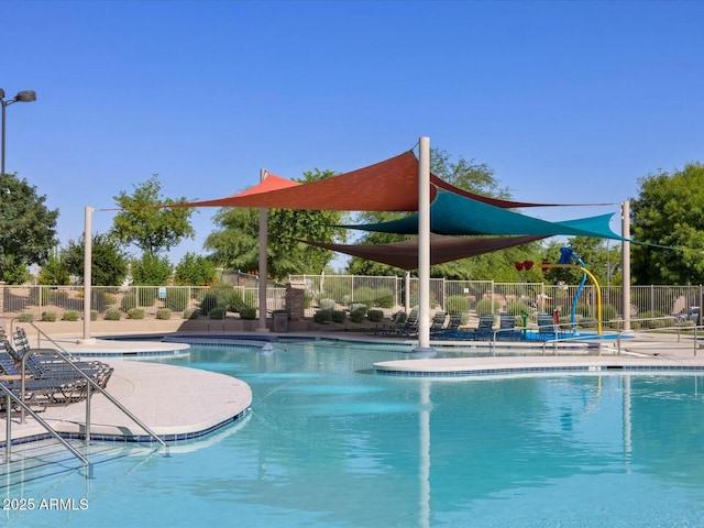 community pool featuring a patio area, a hot tub, and fence