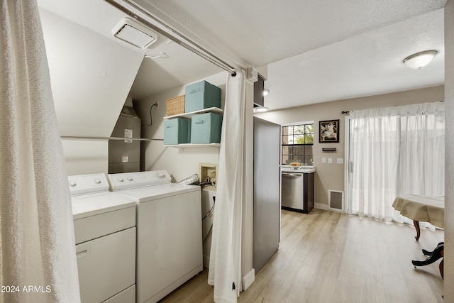 4901 E Kelton Ln Unit 1006, Scottsdale, AZ 85254 - laundry room featuring washing machine and clothes dryer and light wood-style floors