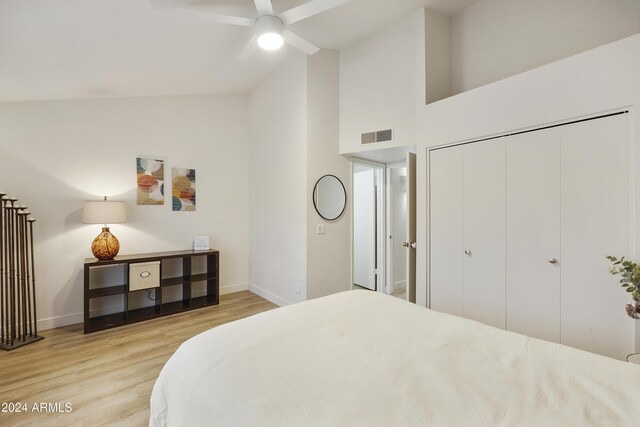 4901 E Kelton Ln Unit 1006, Scottsdale, AZ 85254 - bedroom with wood finished floors, high vaulted ceiling, a closet, and a ceiling fan
