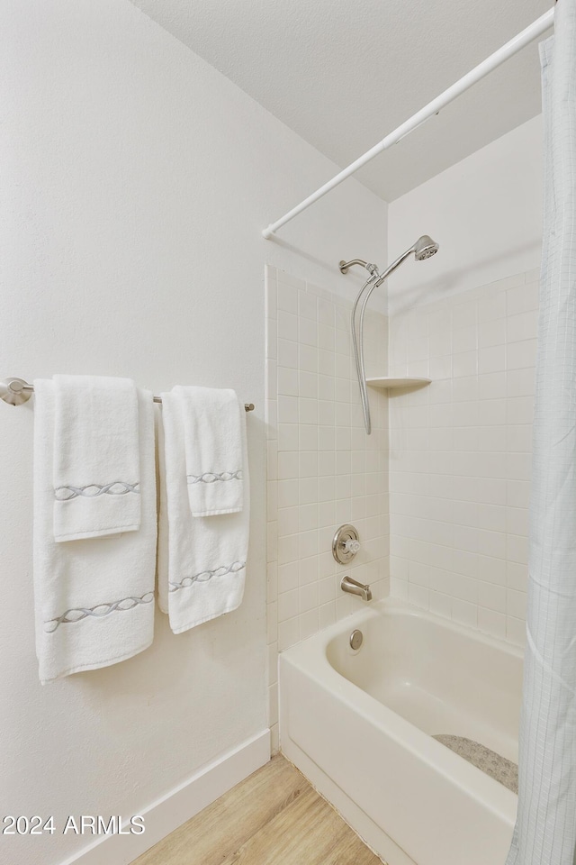 4901 E Kelton Ln Unit 1006, Scottsdale, AZ 85254 - bathroom featuring shower / tub combo and wood finished floors