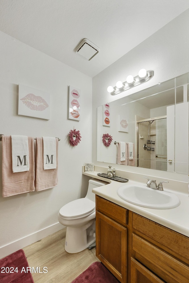 4901 E Kelton Ln Unit 1006, Scottsdale, AZ 85254 - full bathroom with vanity, a shower with shower door, and wood finished floors