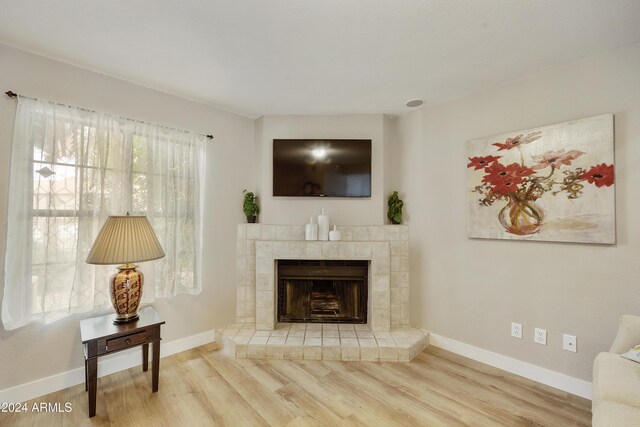 4901 E Kelton Ln Unit 1006, Scottsdale, AZ 85254 - living room with wood finished floors and a tile fireplace