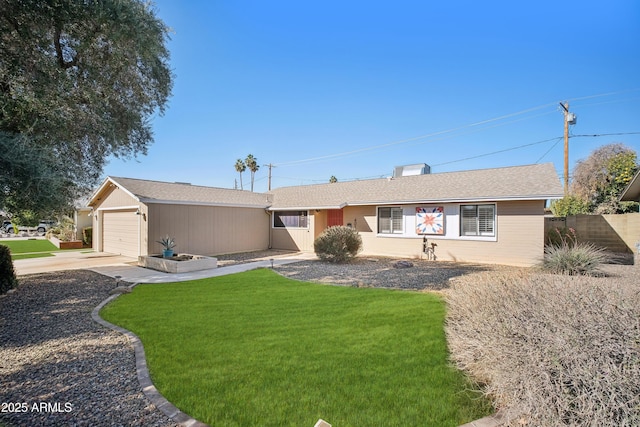 ranch-style home featuring a garage and a front yard