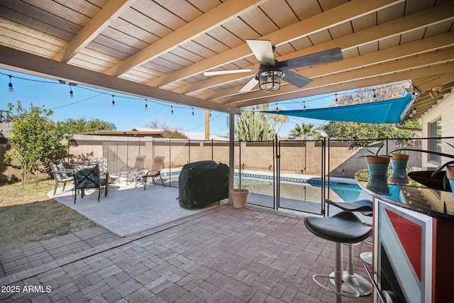 view of patio featuring an outdoor bar, area for grilling, and a fenced in pool