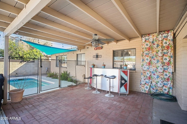 view of patio featuring exterior bar and a fenced in pool