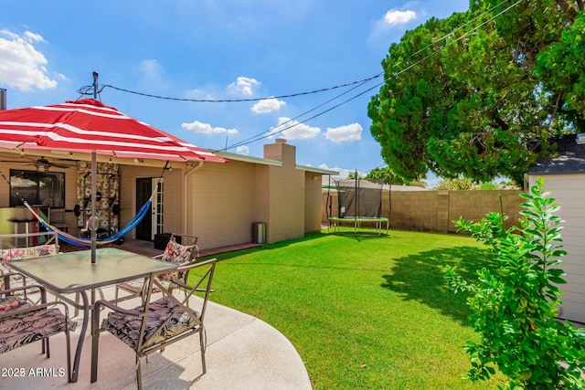 view of yard featuring a patio area and a trampoline