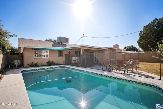 view of swimming pool featuring cooling unit and a patio area