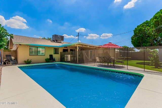 view of pool featuring a patio area and central AC unit