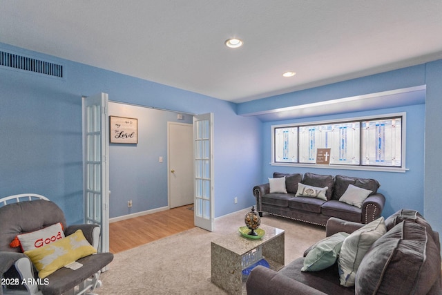 living room with french doors and light carpet