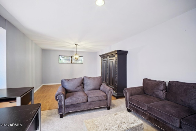 living room with an inviting chandelier and light hardwood / wood-style floors