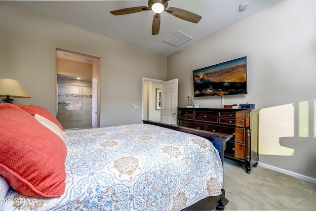 bedroom with ensuite bath, ceiling fan, and light colored carpet