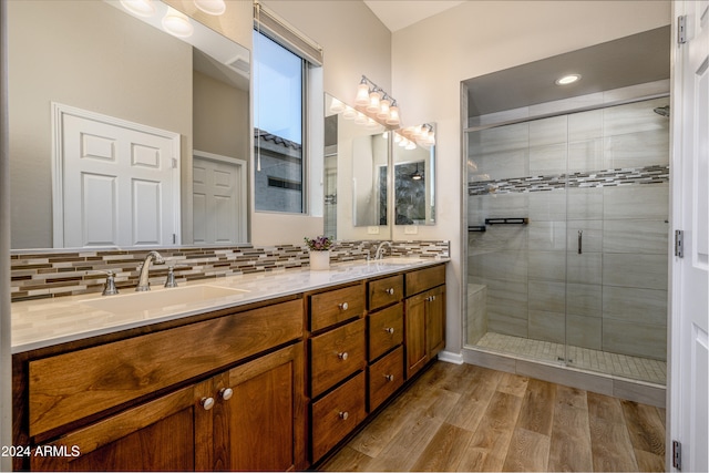 bathroom featuring an enclosed shower, backsplash, and vanity