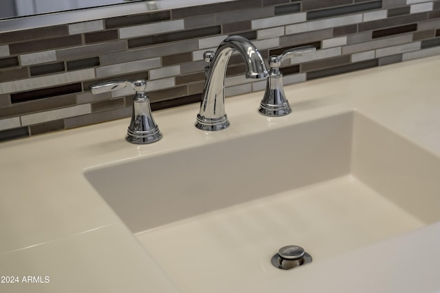 details featuring sink and backsplash