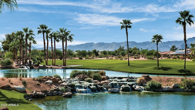 surrounding community featuring a lawn and a water and mountain view