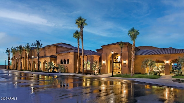 view of outdoor building at dusk