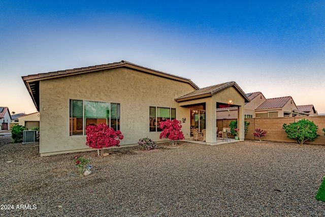 view of front of home featuring a patio and central AC unit