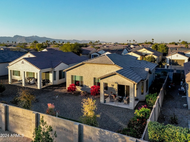 back of property with a patio and a mountain view