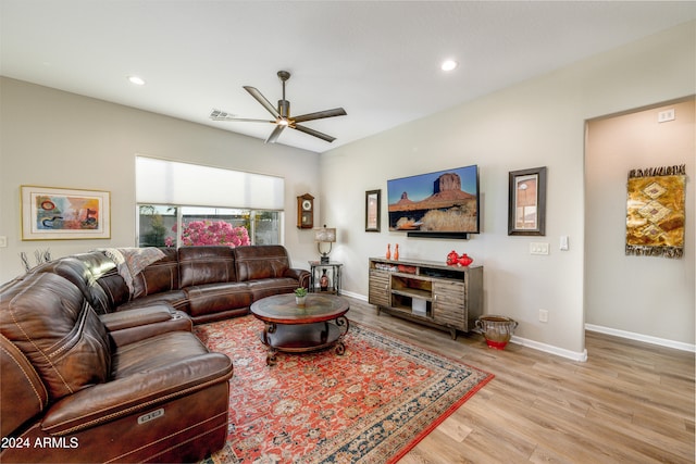 living room with ceiling fan and light hardwood / wood-style flooring