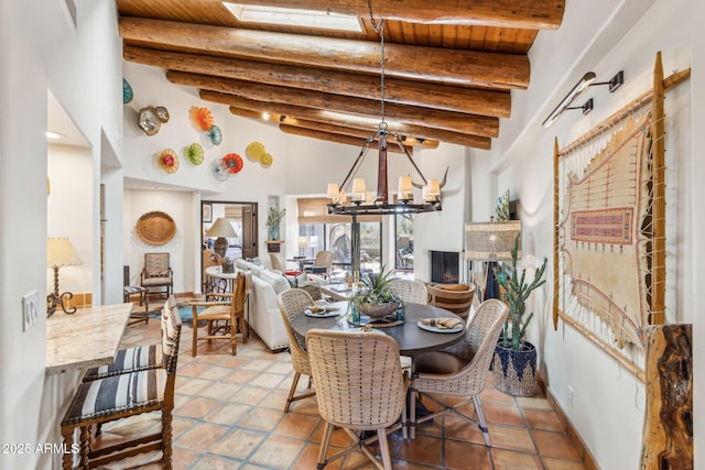 dining area with beam ceiling, tile patterned flooring, wood ceiling, and a notable chandelier