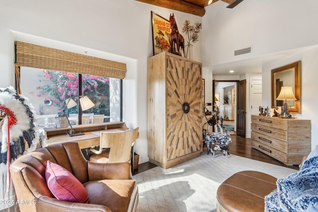 living room featuring beamed ceiling, light wood-type flooring, wooden ceiling, and high vaulted ceiling