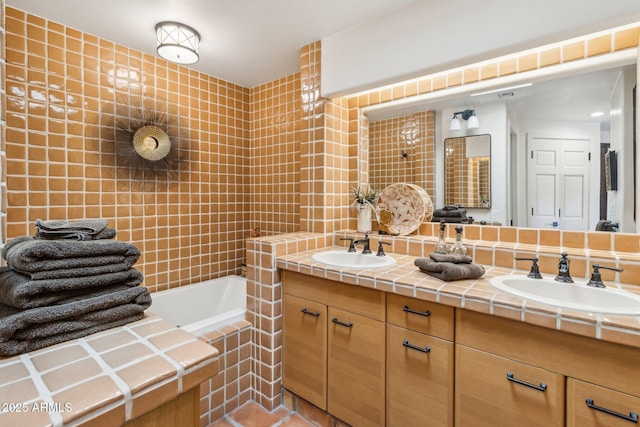 bathroom with tiled bath and vanity