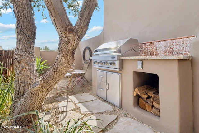 view of patio with an outdoor kitchen and area for grilling