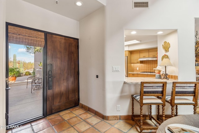 foyer entrance with light tile patterned floors