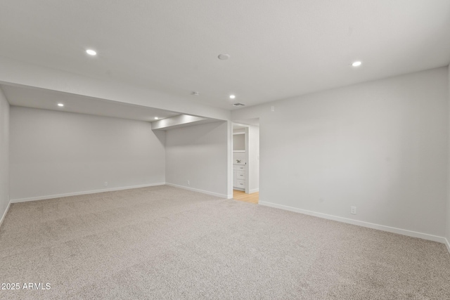 finished below grade area featuring recessed lighting and light colored carpet