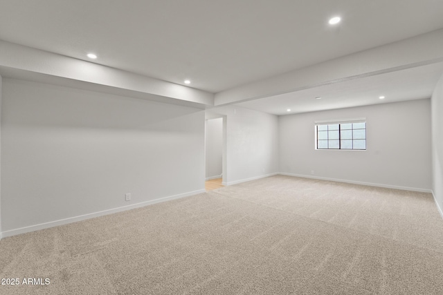below grade area featuring recessed lighting, baseboards, and light carpet