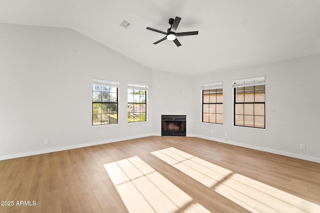 unfurnished living room featuring visible vents, a fireplace, light wood-style floors, ceiling fan, and vaulted ceiling