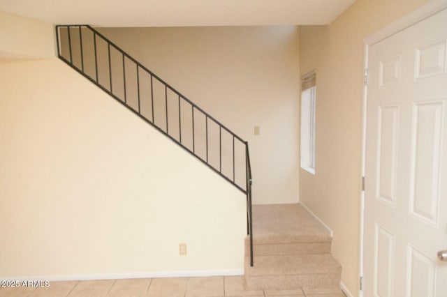 stairway with tile patterned floors