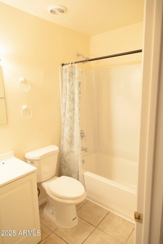 full bathroom featuring tile patterned flooring, vanity, shower / tub combo, and toilet