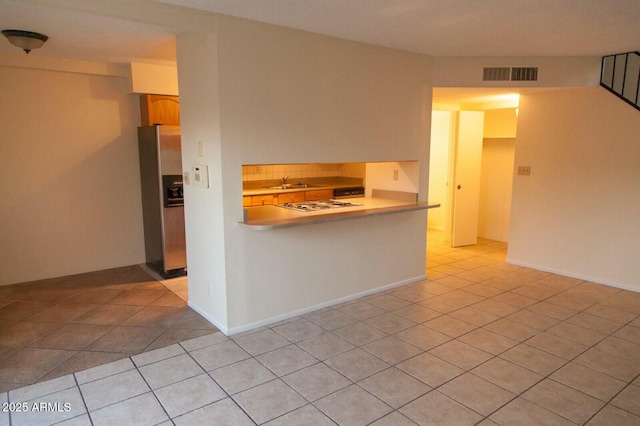 interior space featuring sink and light tile patterned floors