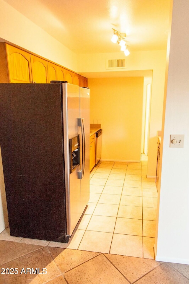 kitchen featuring stainless steel appliances and light tile patterned floors