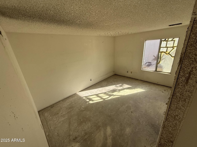 spare room featuring a textured ceiling