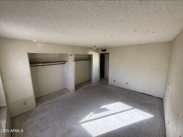 unfurnished bedroom with a textured ceiling