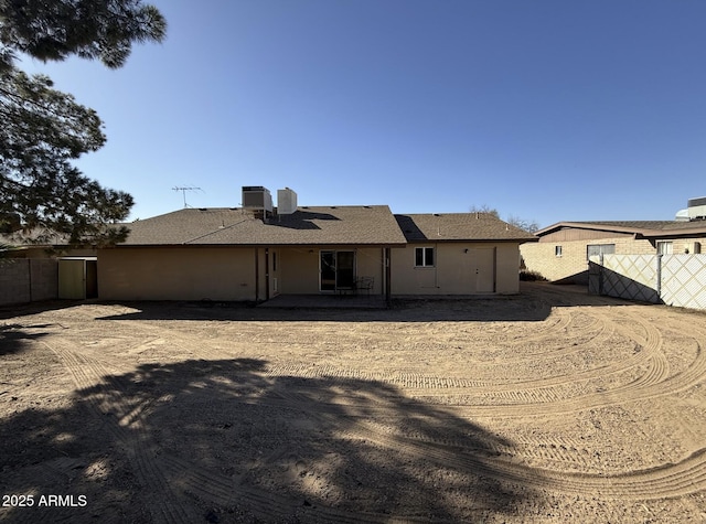 back of property featuring central AC