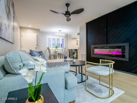 living room with hardwood / wood-style flooring and ceiling fan