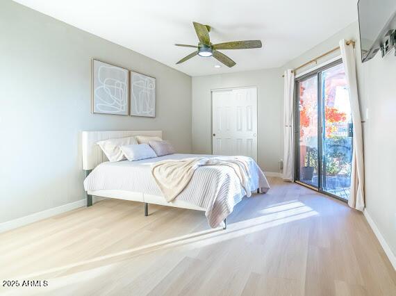 bedroom with ceiling fan, access to outside, and light hardwood / wood-style floors